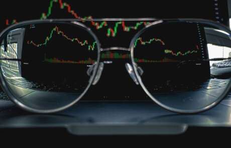 Glasses in front of data screen indicating why private equity investing in franchise companies need to look at satisfaction data